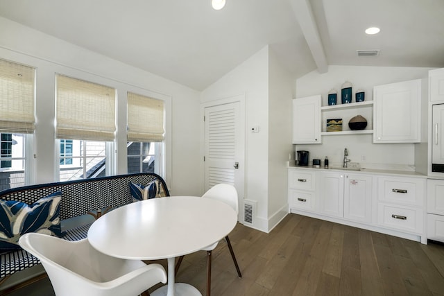 dining space featuring baseboards, vaulted ceiling with beams, visible vents, and dark wood-type flooring