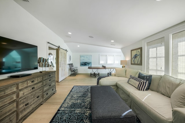 living room with light wood-style flooring, a barn door, baseboards, recessed lighting, and lofted ceiling