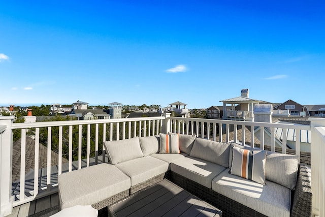 wooden terrace with outdoor lounge area and a residential view