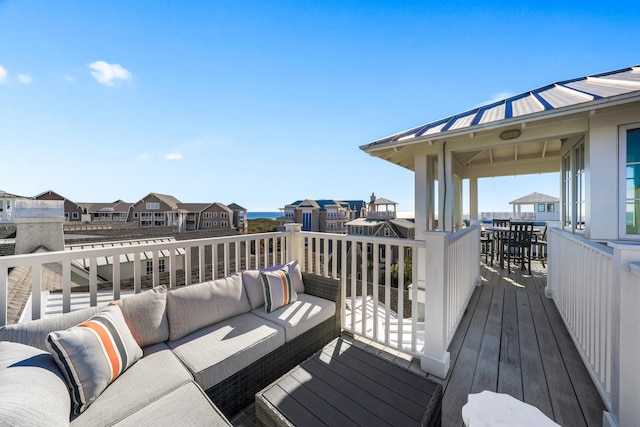 wooden deck with an outdoor hangout area and a residential view