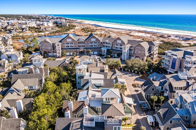 drone / aerial view featuring a beach view and a water view