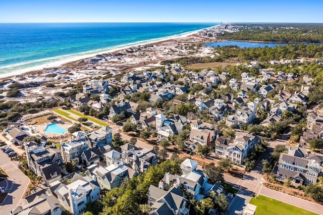 birds eye view of property with a beach view and a water view