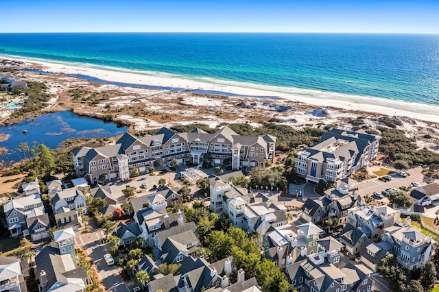 drone / aerial view featuring a beach view and a water view