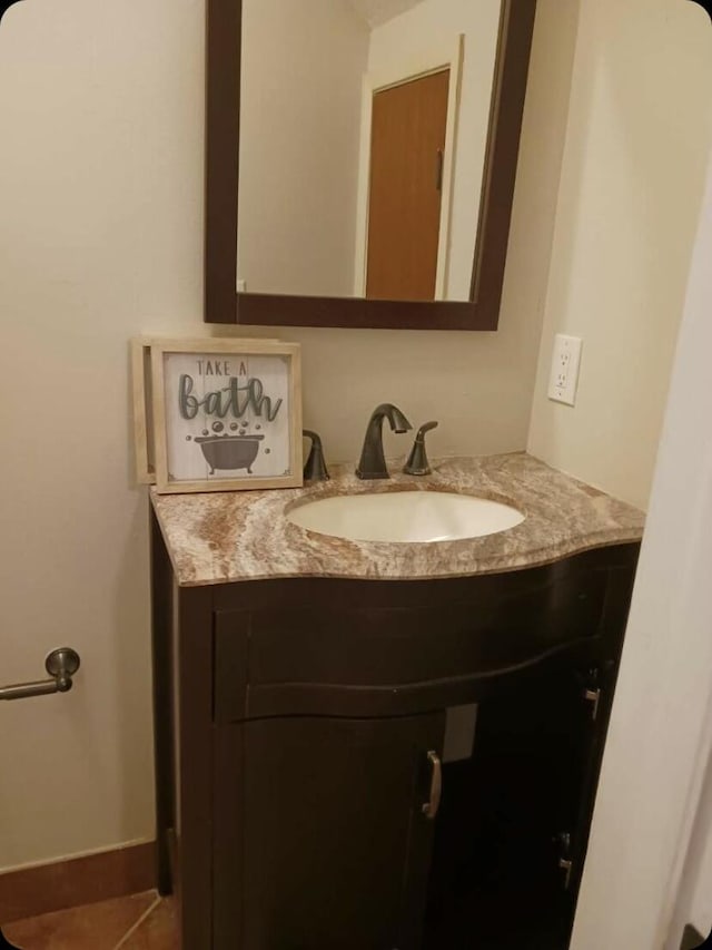 bathroom featuring tile patterned flooring and vanity