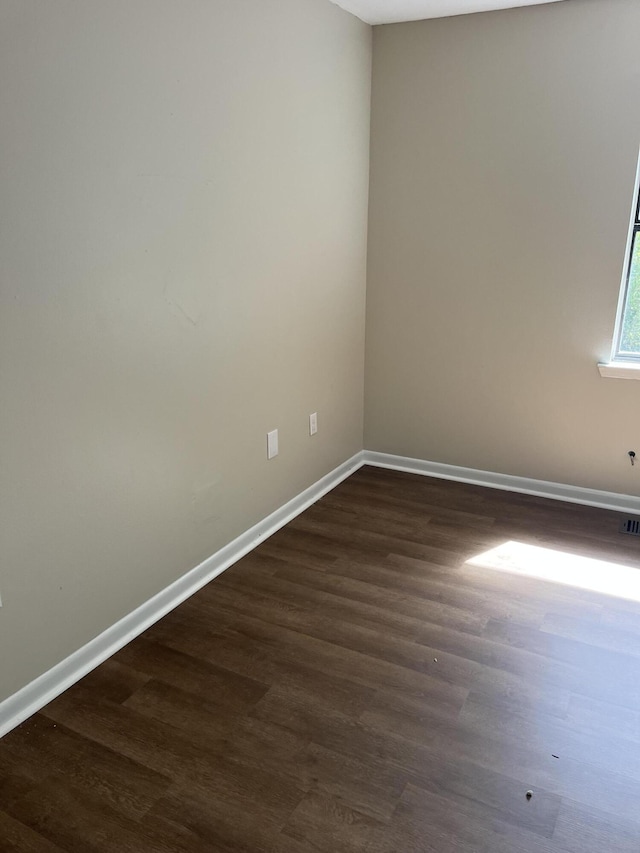 spare room featuring dark hardwood / wood-style floors