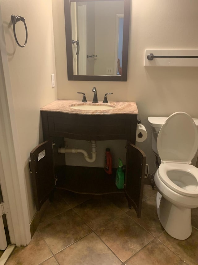 bathroom with tile patterned floors, vanity, and toilet