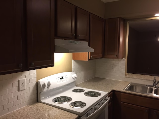 kitchen featuring backsplash, dark brown cabinetry, sink, and white electric range oven