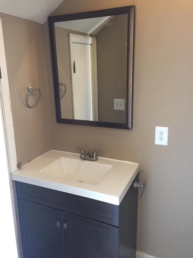 bathroom with a textured ceiling and vanity