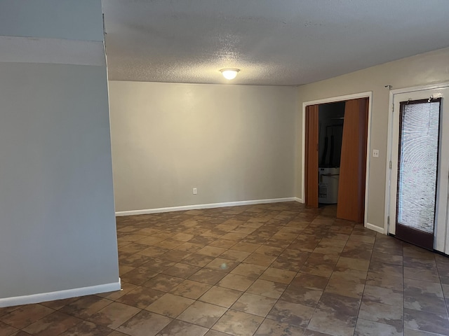 unfurnished room with a textured ceiling