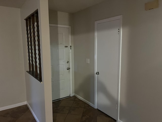 hallway with dark tile patterned floors