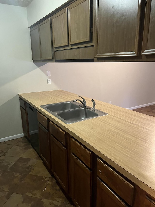 kitchen with dishwasher, dark brown cabinets, and sink