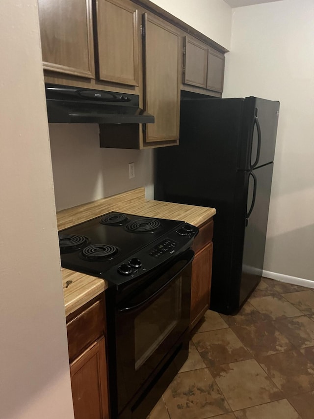 kitchen featuring black appliances and wood counters