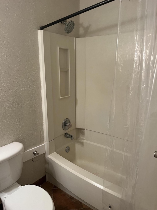 bathroom featuring tile patterned flooring, toilet, and shower / tub combo with curtain