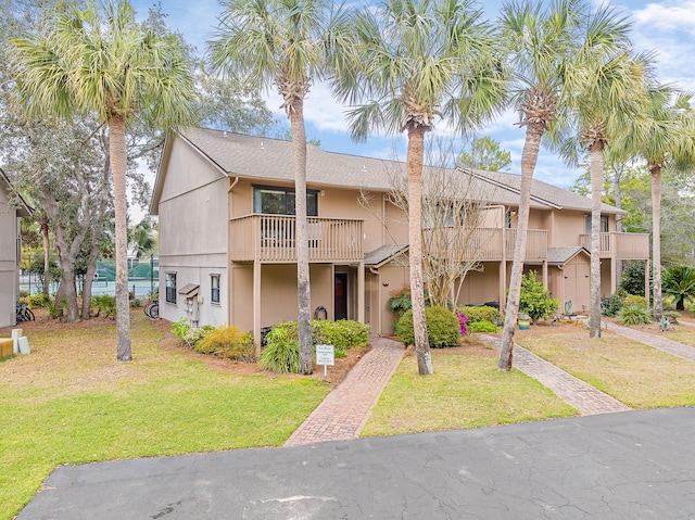 view of front of property with a balcony and a front yard