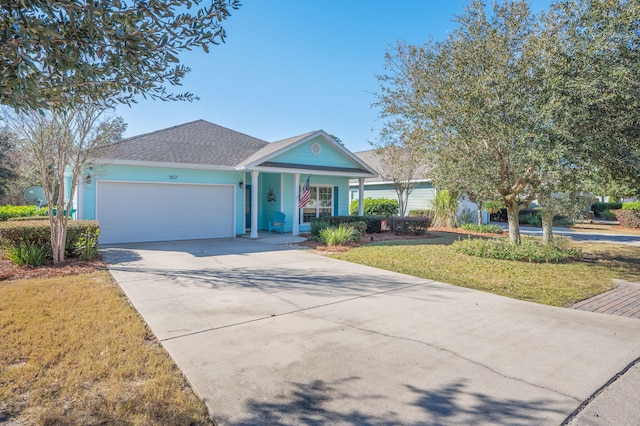 view of front of property featuring a front lawn, a porch, and a garage