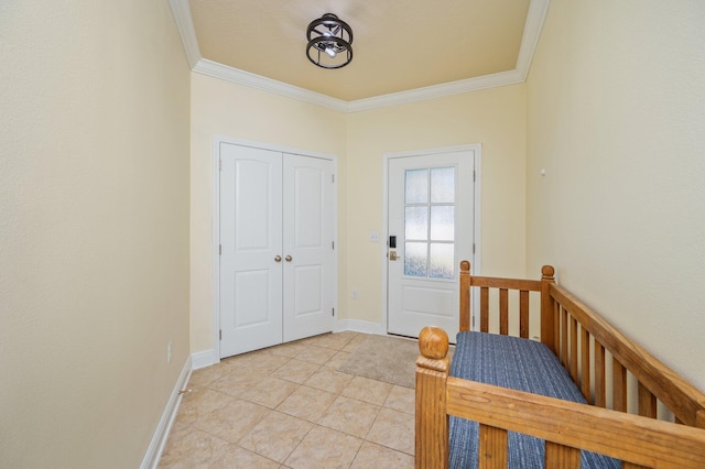 entryway with crown molding and light tile patterned floors