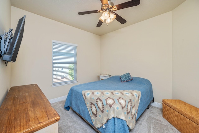 bedroom featuring light carpet and ceiling fan