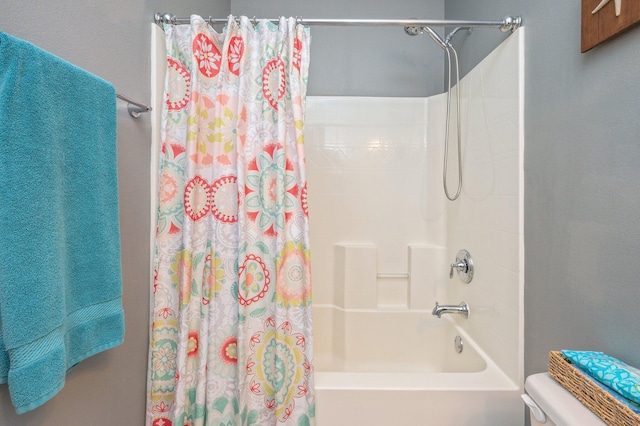 bathroom with shower / bath combo and toilet