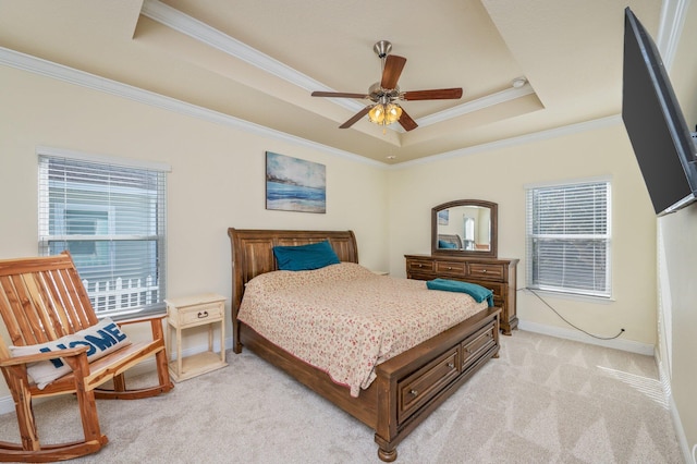 bedroom with a raised ceiling, multiple windows, ceiling fan, and light carpet