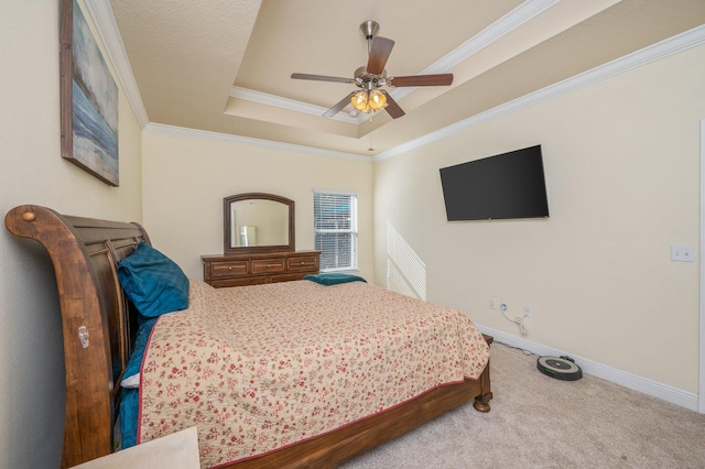 bedroom featuring carpet flooring, a raised ceiling, ceiling fan, and ornamental molding