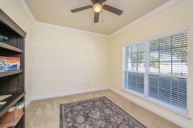 carpeted spare room with ceiling fan and crown molding