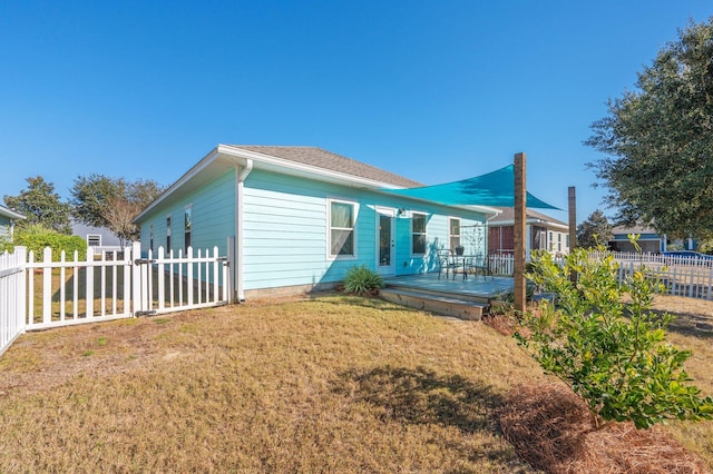 back of house featuring a yard and a wooden deck