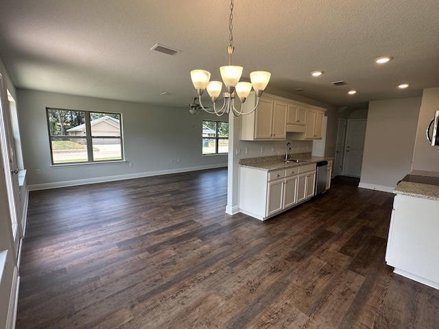 169 Ridgeway Cir, Crestview, FL 32536 - kitchen with appliances with stainless steel finishes, a chandelier, a textured ceiling, open floor plan, and white cabinetry