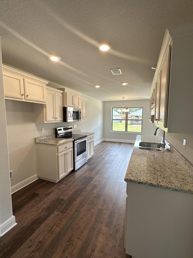 kitchen featuring dark hardwood / wood-style flooring, a textured ceiling, stainless steel appliances, sink, and white cabinets