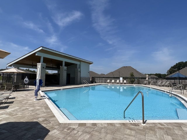 pool featuring a patio area and fence