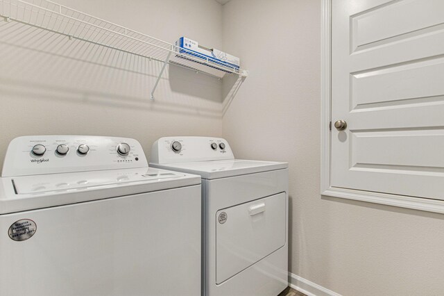 laundry room with laundry area, baseboards, and separate washer and dryer