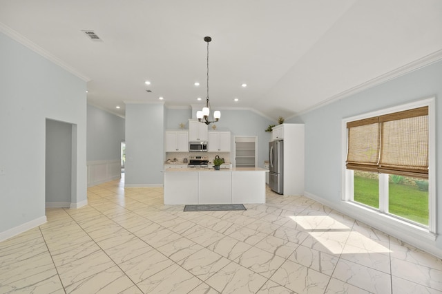 kitchen with crown molding, pendant lighting, a center island, and stainless steel appliances