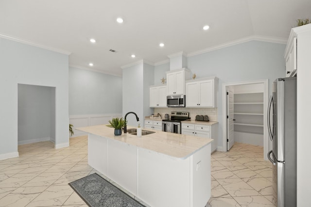 kitchen featuring white cabinets, stainless steel appliances, a center island with sink, and sink