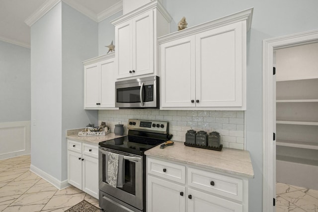 kitchen with white cabinets, backsplash, stainless steel appliances, and light stone countertops