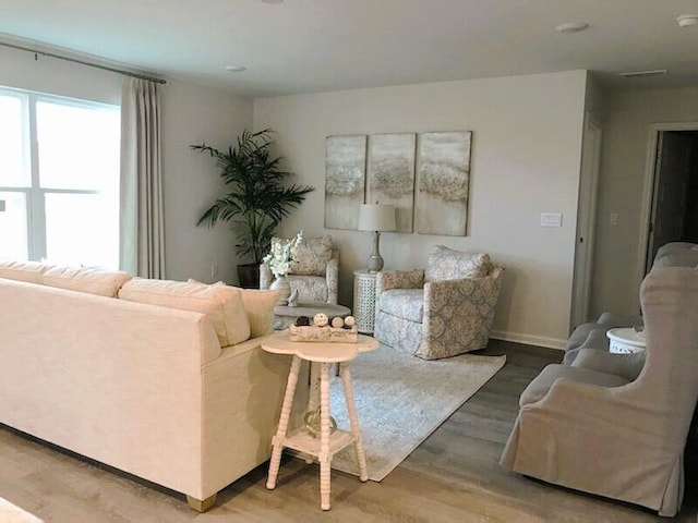 living room featuring wood finished floors and baseboards