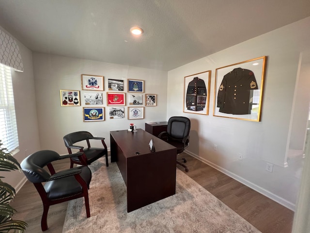 office area with wood finished floors and baseboards