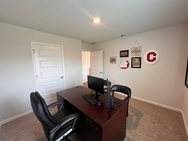 carpeted office space featuring baseboards and visible vents