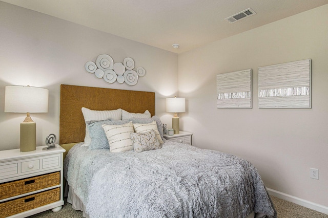 carpeted bedroom featuring visible vents and baseboards