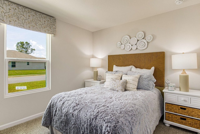 bedroom featuring baseboards and carpet flooring