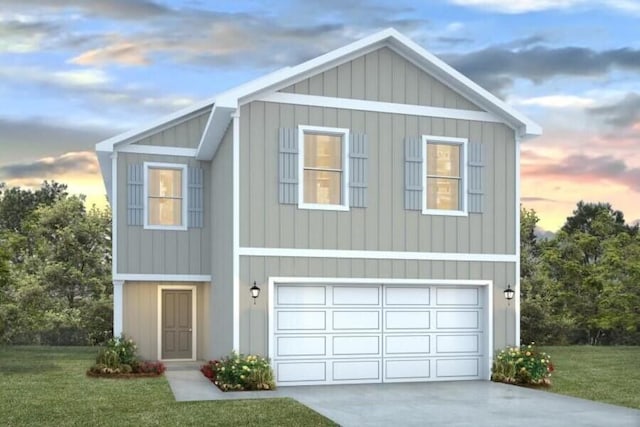 view of front of property featuring a yard and a garage