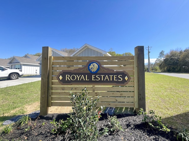 community / neighborhood sign with a lawn