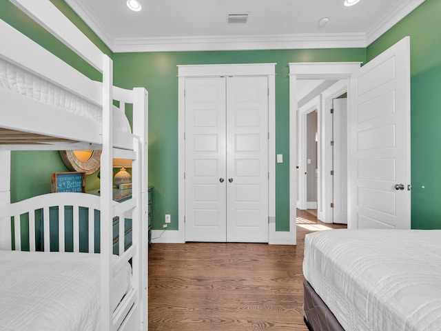 bedroom with dark hardwood / wood-style floors and crown molding