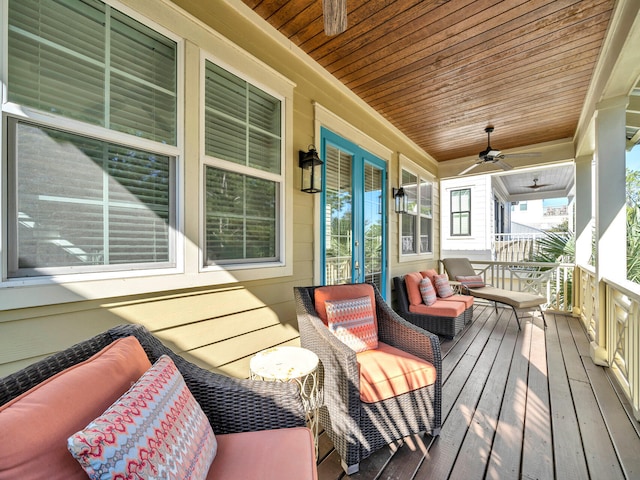 wooden terrace featuring ceiling fan and a porch