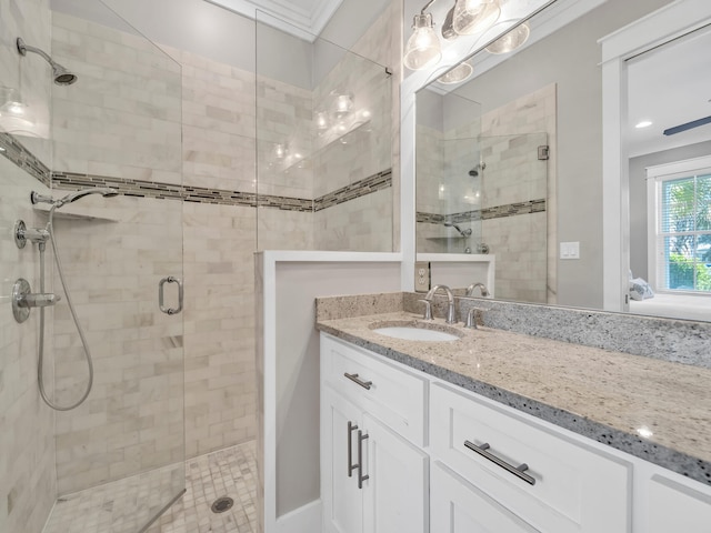 bathroom featuring vanity and a shower with shower door