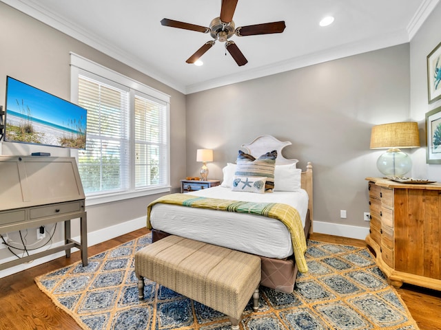 bedroom with hardwood / wood-style floors, ceiling fan, and crown molding