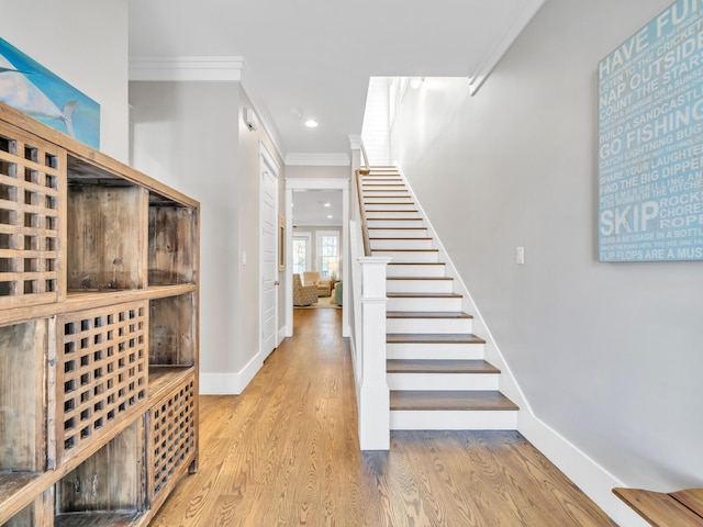 interior space featuring light wood-type flooring and crown molding