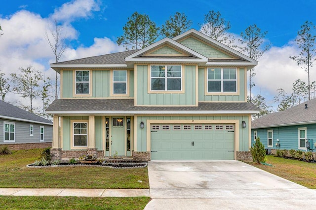 craftsman-style house featuring a front yard and a garage