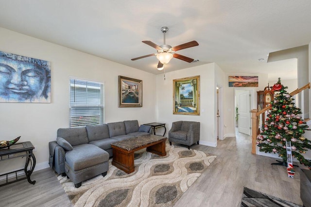 living room featuring light hardwood / wood-style floors and ceiling fan