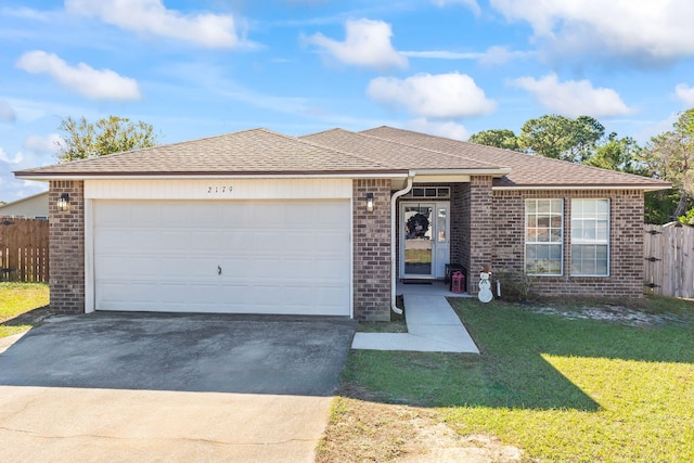 single story home with a front yard and a garage