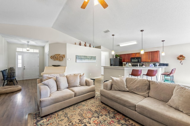 living room with ceiling fan, wood-type flooring, and vaulted ceiling