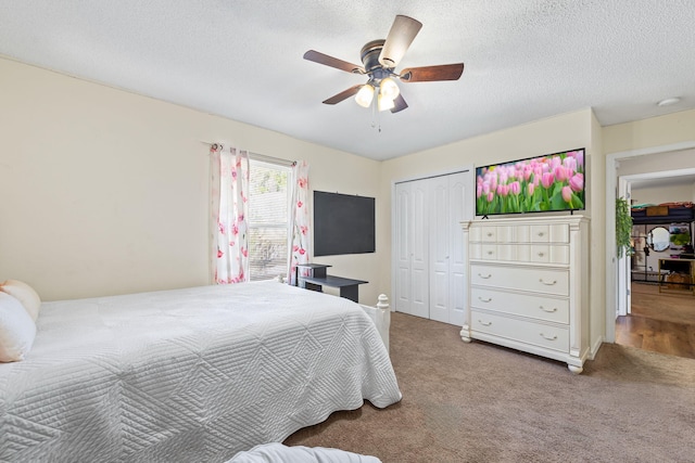 bedroom with carpet, a textured ceiling, a closet, and ceiling fan